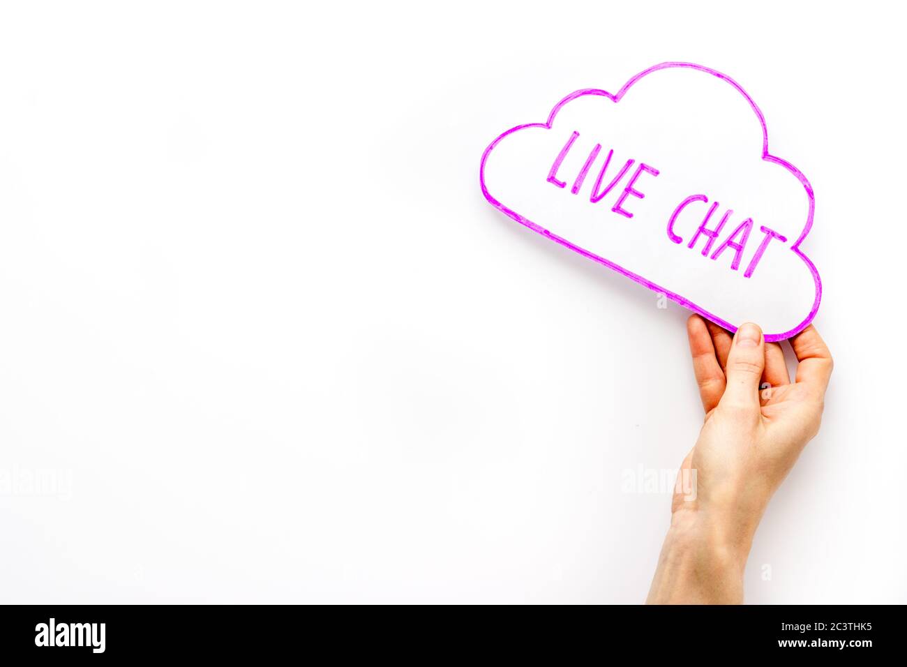 Live chat concept - bubble in hand on white desk top view Stock Photo -  Alamy