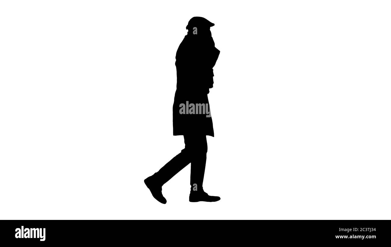 Silhouette Adult man wears protective medical mask talking on the phone and walking. Stock Photo
