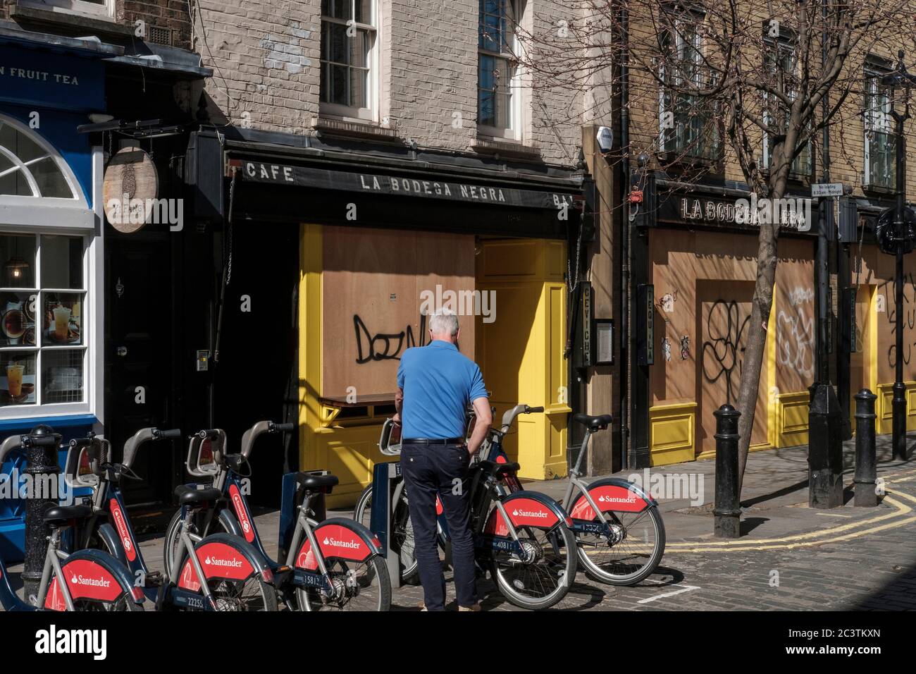 Person rents a bicycle  during Covid 19 lockdowm in Soho, Old Compton Street, London,England Stock Photo