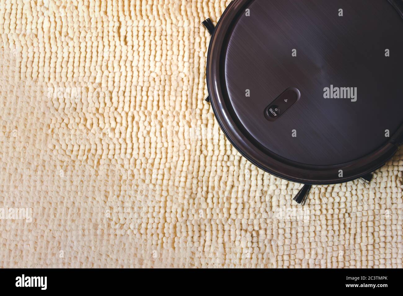 Round Robot Vacuum Cleaner. Indoor, housework Holding clean Stock Photo