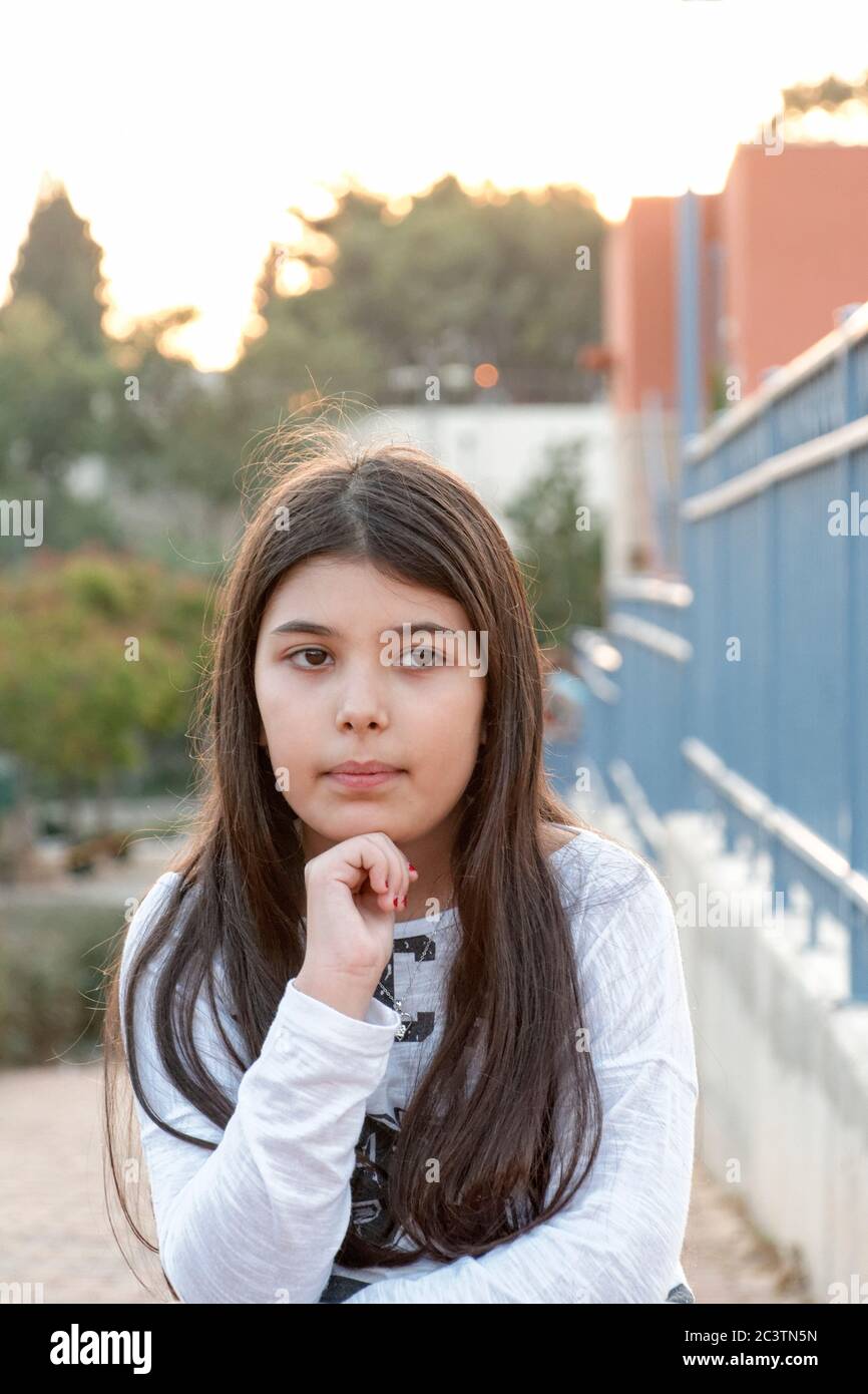 Young girl of 9 in deep thought Stock Photo