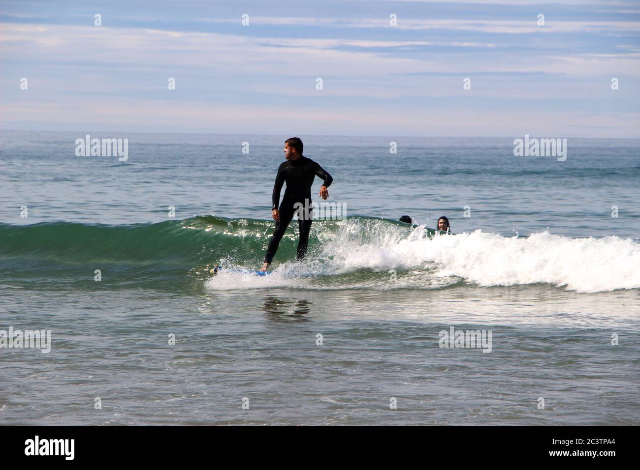 Standing surfer wearing wetsuit hi-res stock photography and images - Alamy