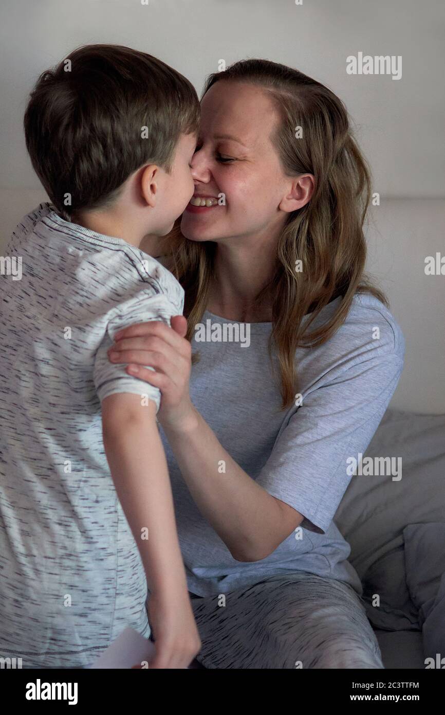 Happy mother's day. Child boy congratulates mom and gives her flowers