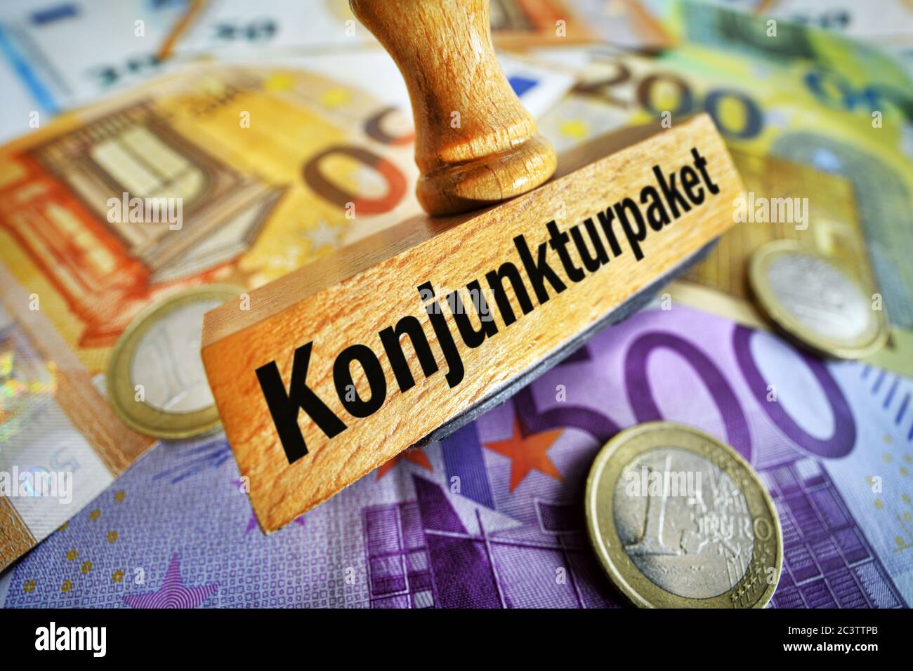 PHOTOMONTAGE, stamp with inscription stimulus on banknotes, FOTOMONTAGE, Stempel mit Aufschrift Konjunkturpaket auf Geldscheinen Stock Photo