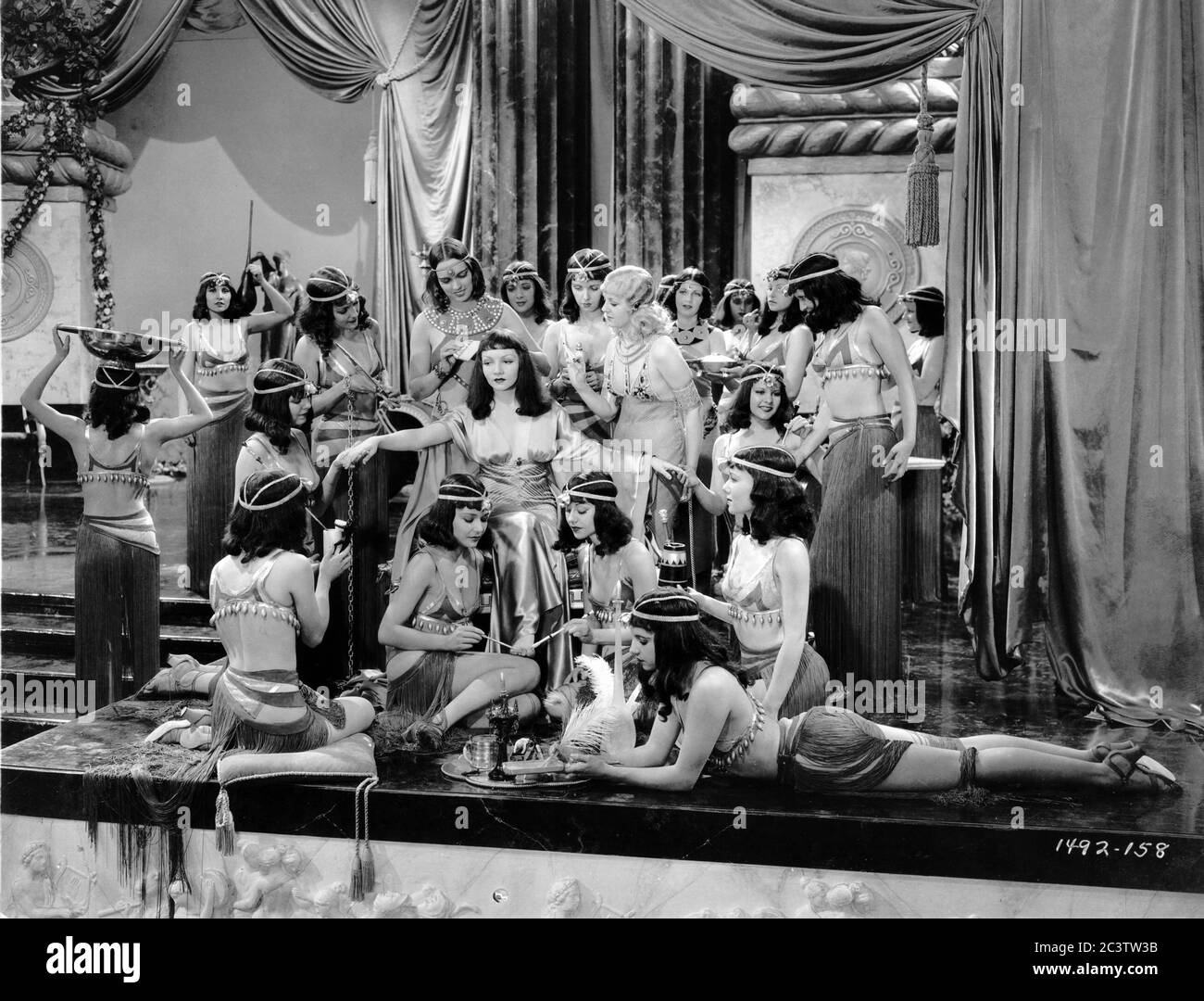 CLAUDETTE COLBERT with Handmaidens including blonde GRACE DURKIN as Iras in CLEOPATRA 1934 director CECIL B. DeMILLE Miss Colbert costume Travis Banton photo by Ray Jones Paramount Pictures Stock Photo