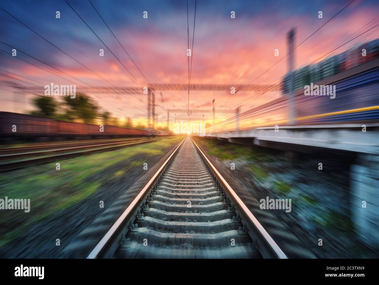 Railroad and sky with clouds at sunset with motion blur effect Stock Photo