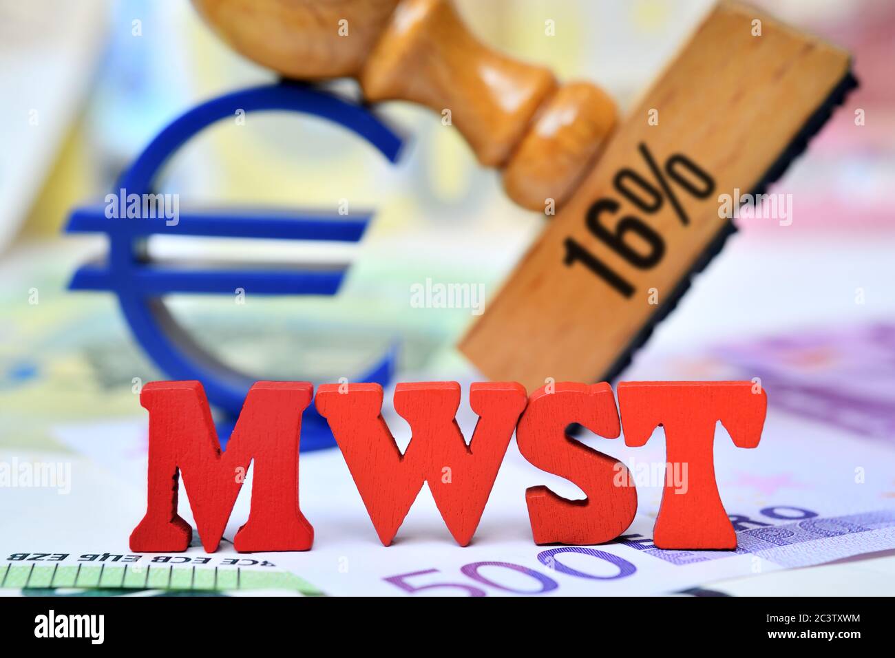 PHOTOMONTAGE, letters form the acronym of VAT in front of a stamp with inscription 16% and Euro sign, symbol photo for reduced value added tax to stim Stock Photo