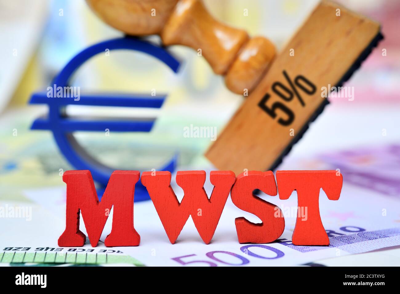 PHOTOMONTAGE, letters form the acronym of VAT in front of a stamp with inscription 5% and Euro sign, symbol photo for reduced reduced VAT to stimulate Stock Photo