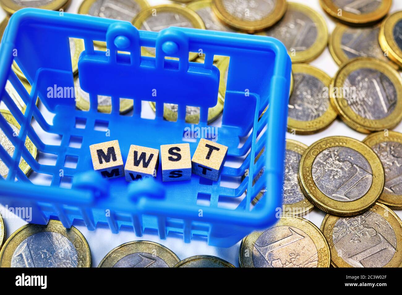 Buchstabenwürfel form the acronym of VAT in a basket, symbol photo for VAT cut to stimulate the economy, Buchstabenwürfel bilden das Kürzel von Mehrwe Stock Photo