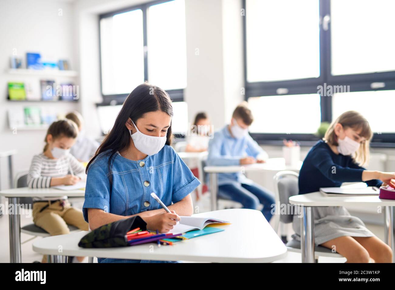 Children with face mask back at school after covid-19 quarantine and ...