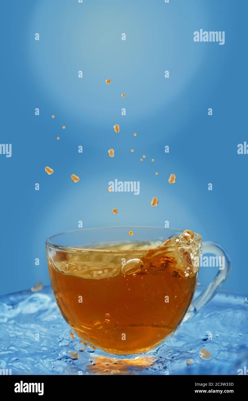 Splashes fly in different directions, iced tea in a Cup Stock Photo Alamy