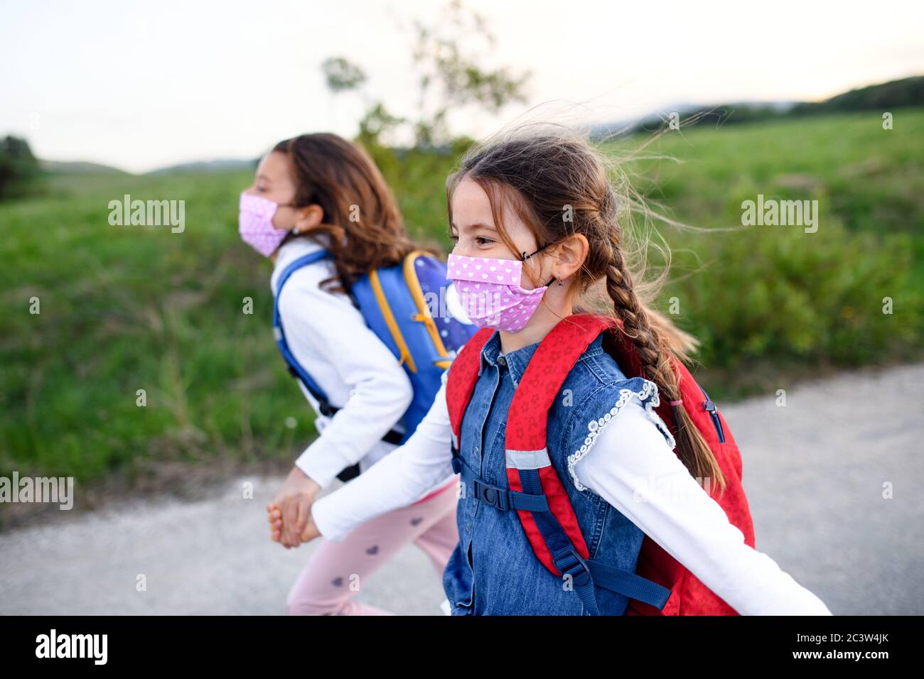 Two girls walking dark hi-res stock photography and images - Alamy
