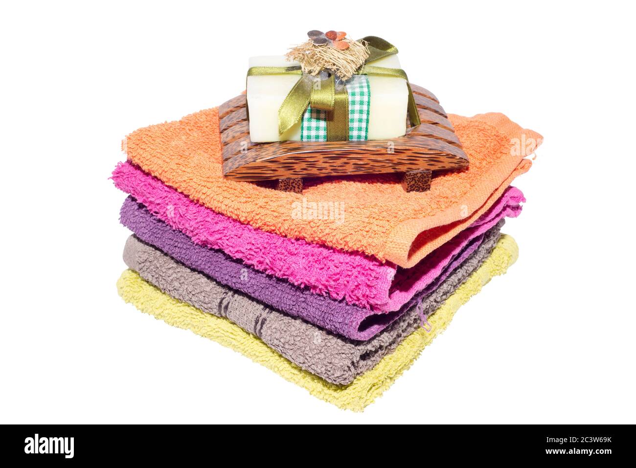 soap and dish on top of facecloths of various shades Stock Photo
