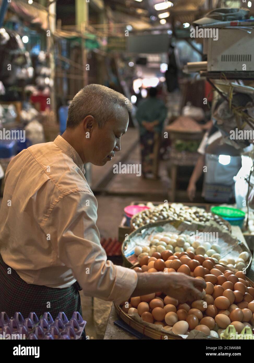 dh Thanlyin Myo Ma Market YANGON MYANMAR Local Burmese vendor man selling eggs markets stall egg seller people south east asian Stock Photo