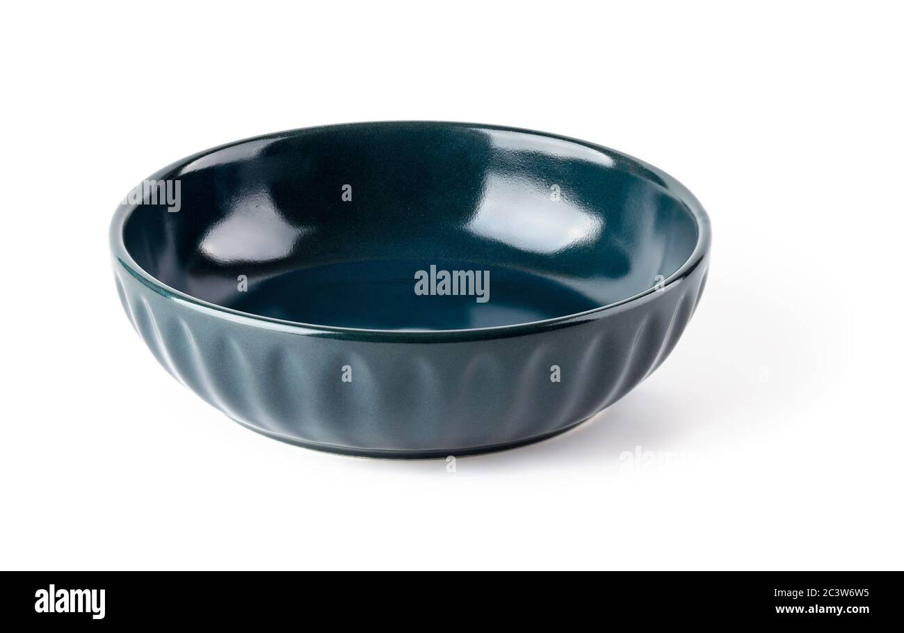 Empty dark blue ceramic bowl isolated on a white background. Clay, ceramics or porcelain crockery and tableware. Front view. Stock Photo