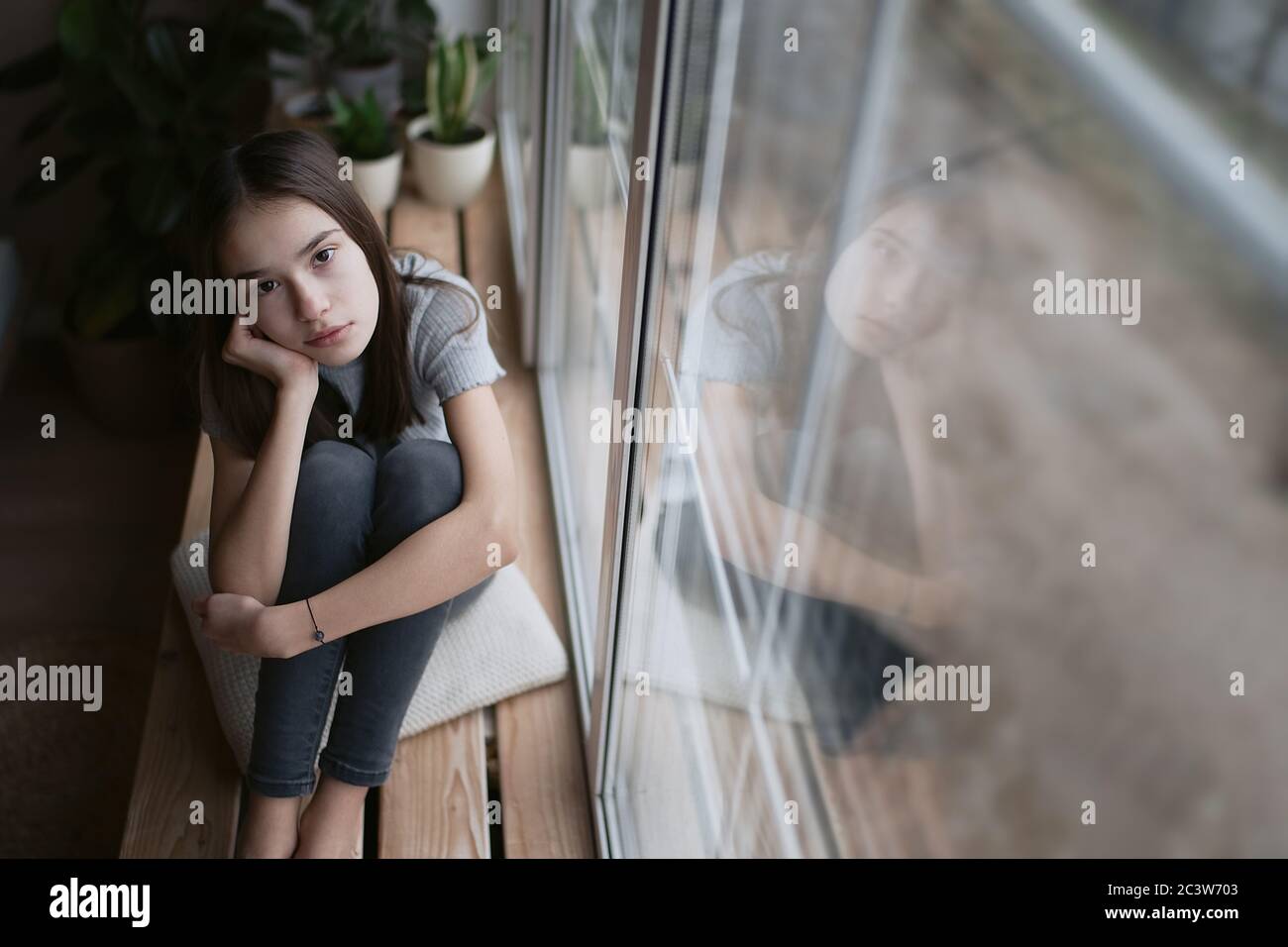Sad teenager feeling bad alone, feeling depressed, regrets of mistake, having problems, adolescent girl with broken heart Stock Photo