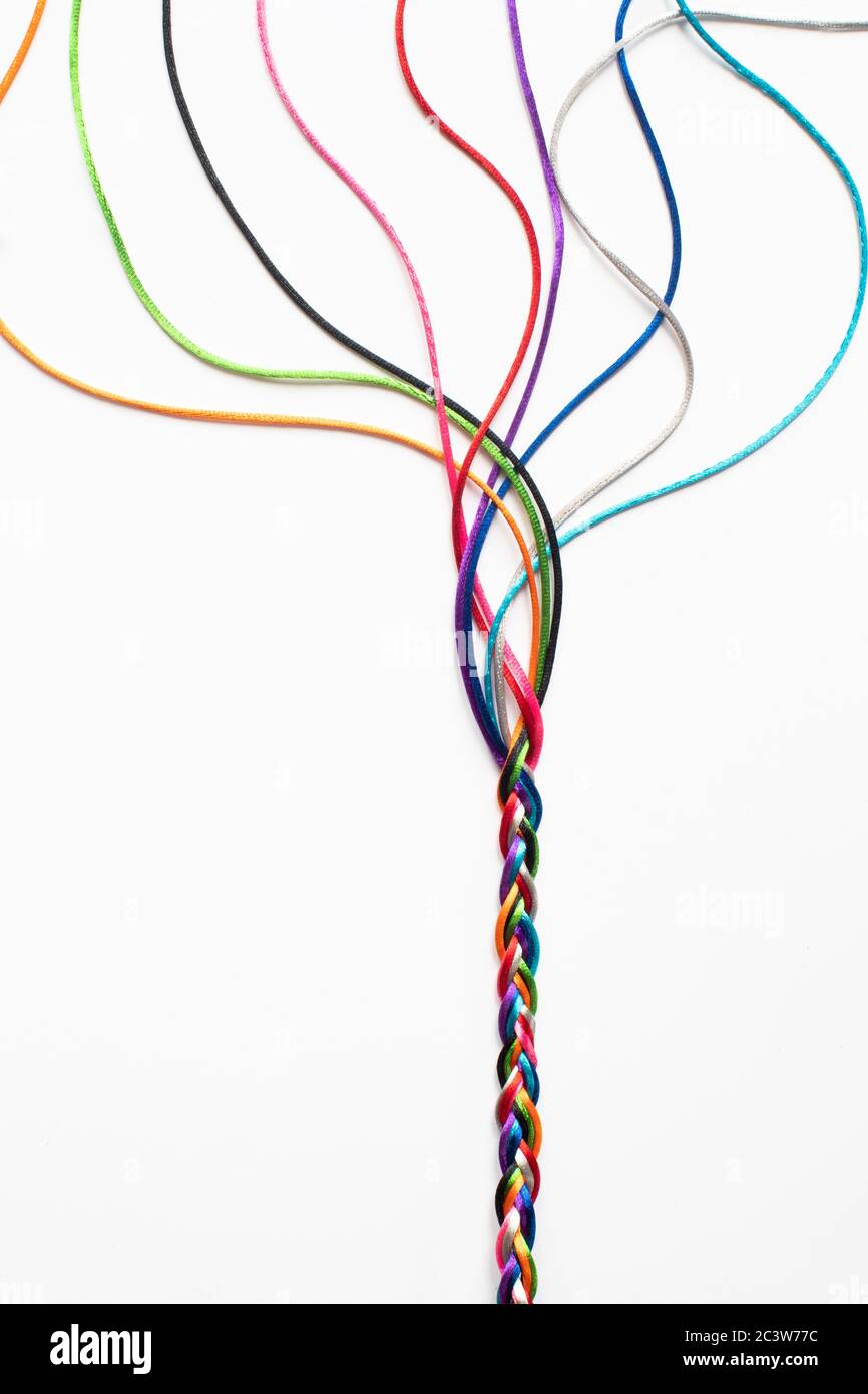 Coloured String Woven Together To Illustrate Concepts Of Unity Society Togetherness and Cooperation Stock Photo