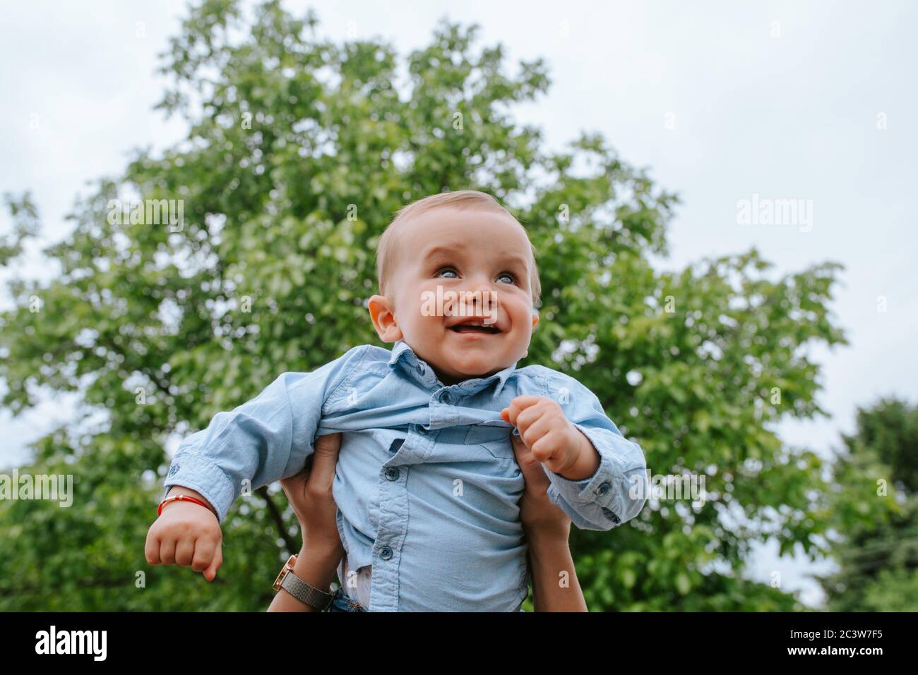 Excited baby boy playing with thermostat of heater Stock Photo - Alamy