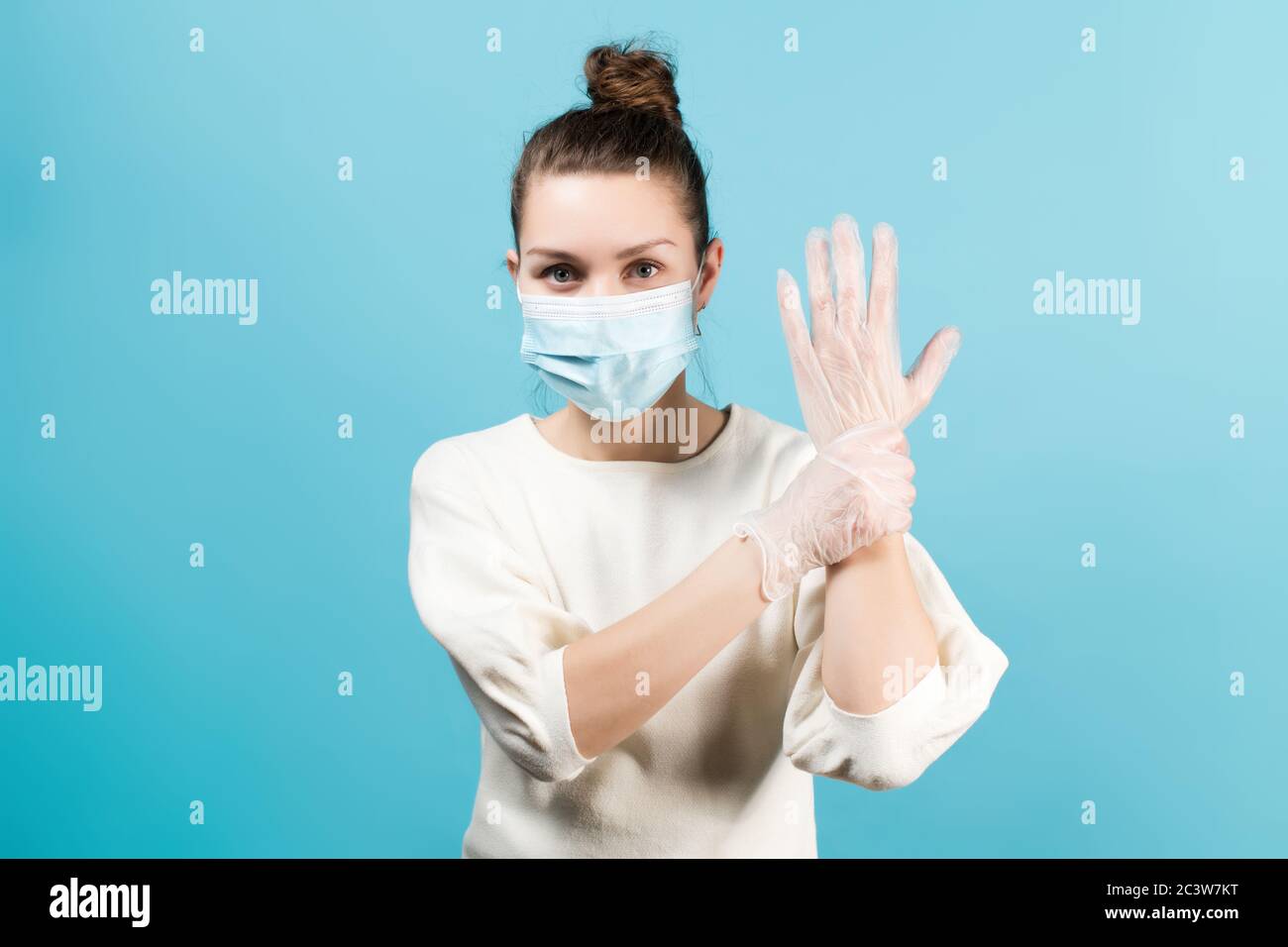 woman paramedic in medical mask and gloves holds her hand with the other hand Stock Photo