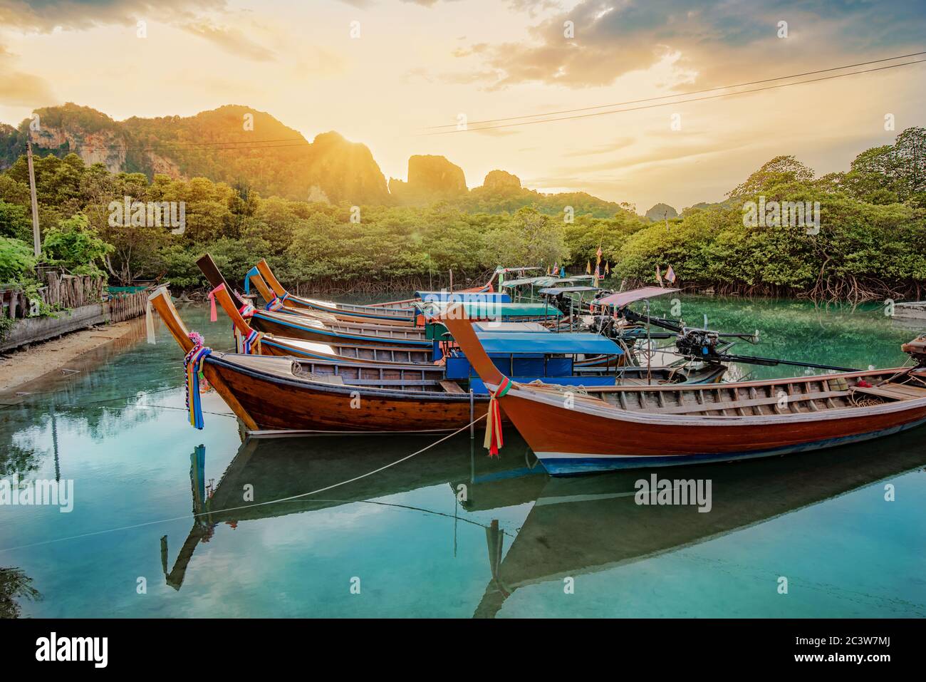 Traditional long-tail boats on the blue lagoon in Krabi region in Thailand in the summertime Stock Photo