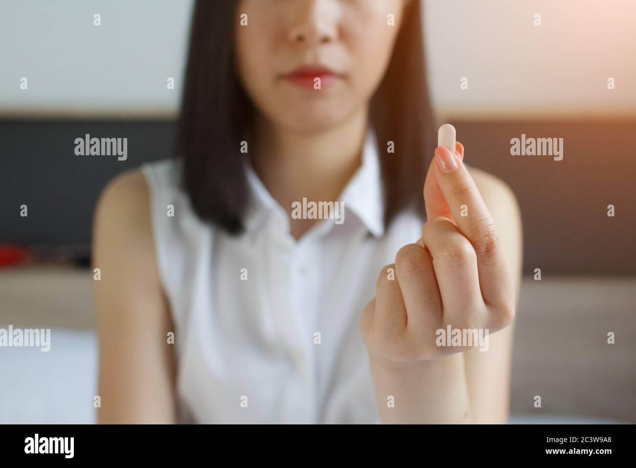 young woman taking pill,  taking drugs. Medicines at work Stock Photo