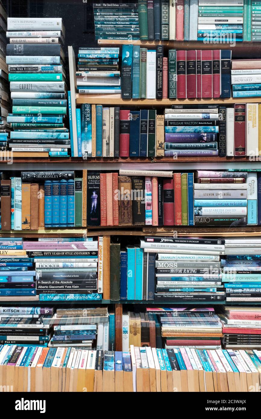 London,UK- Shelves stacked with books in antiquarian bookstore, Stock Photo