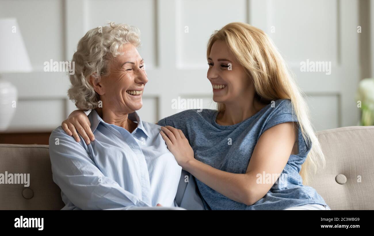 Grownup daughter and elderly mother spend weekend together enjoy conversation Stock Photo