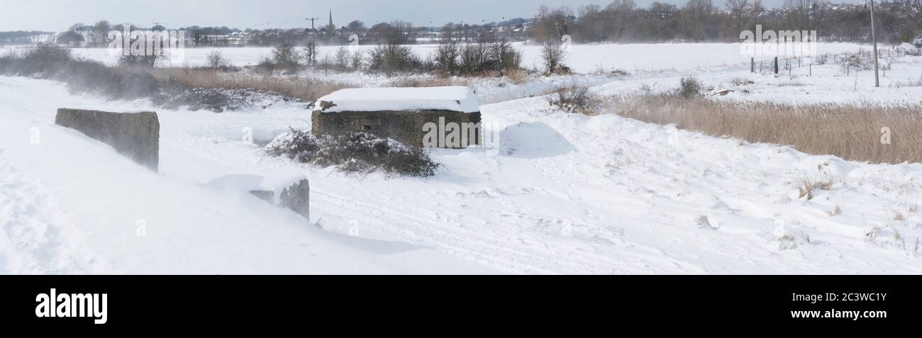 A world war two GHQ anti tank bunker. Stands ready, as in war time conditions with it's anti-tank stops. During a winter blizzard from Storm Emma. Stock Photo