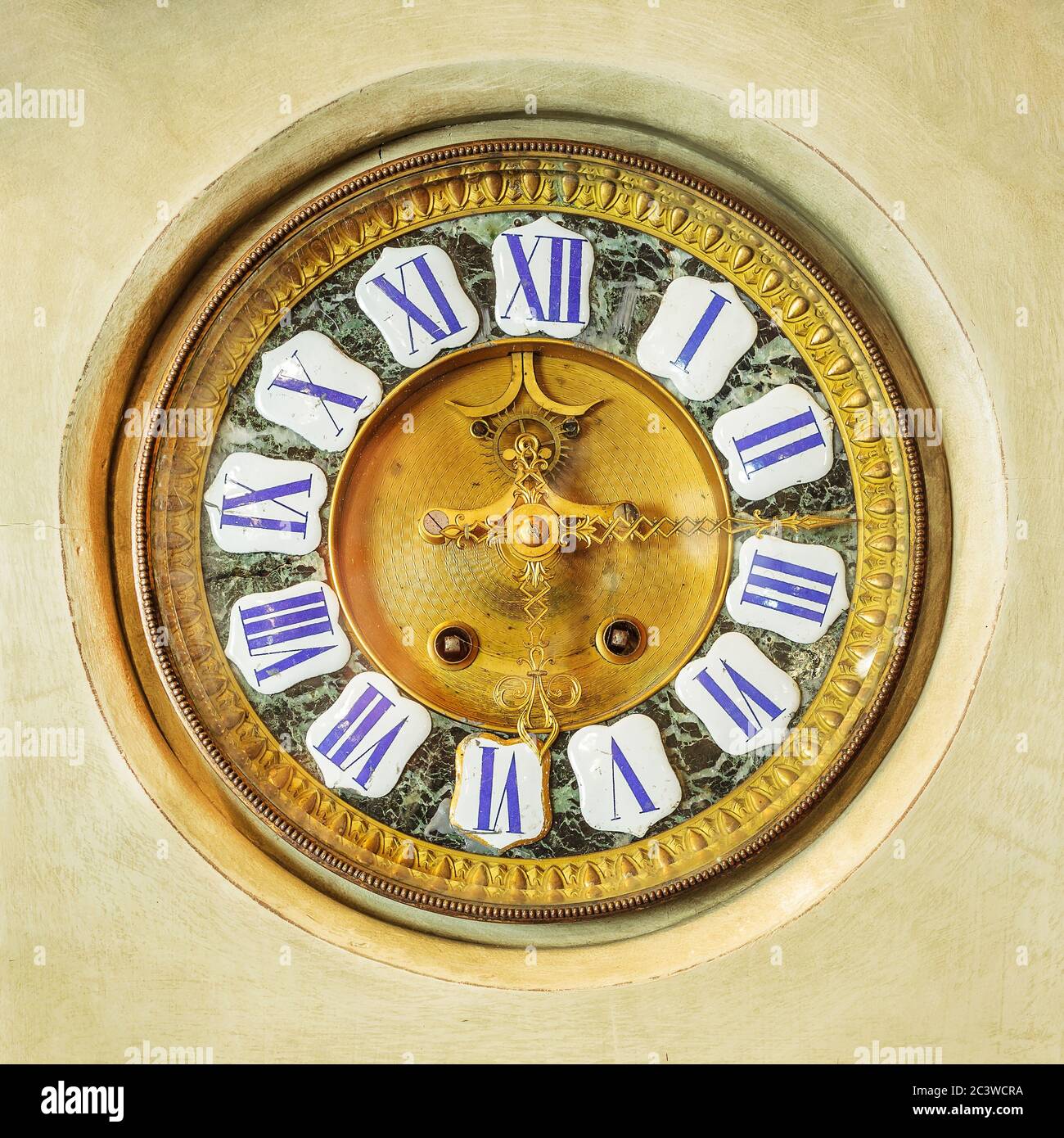 Authentic ancient ornamental golden clock with enamel roman numbers