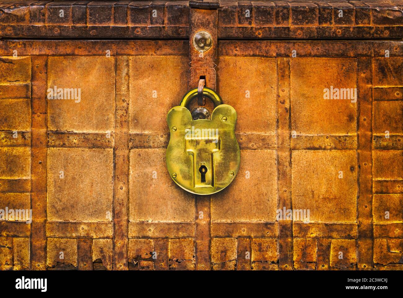 Retro styled image of an ancient locked rusted treasure chest with