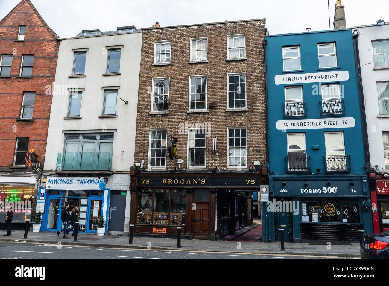 Dublin, Ireland - December 30, 2019: Dame Street with restaurants, irish pub and people around in the center of Dublin, Ireland Stock Photo