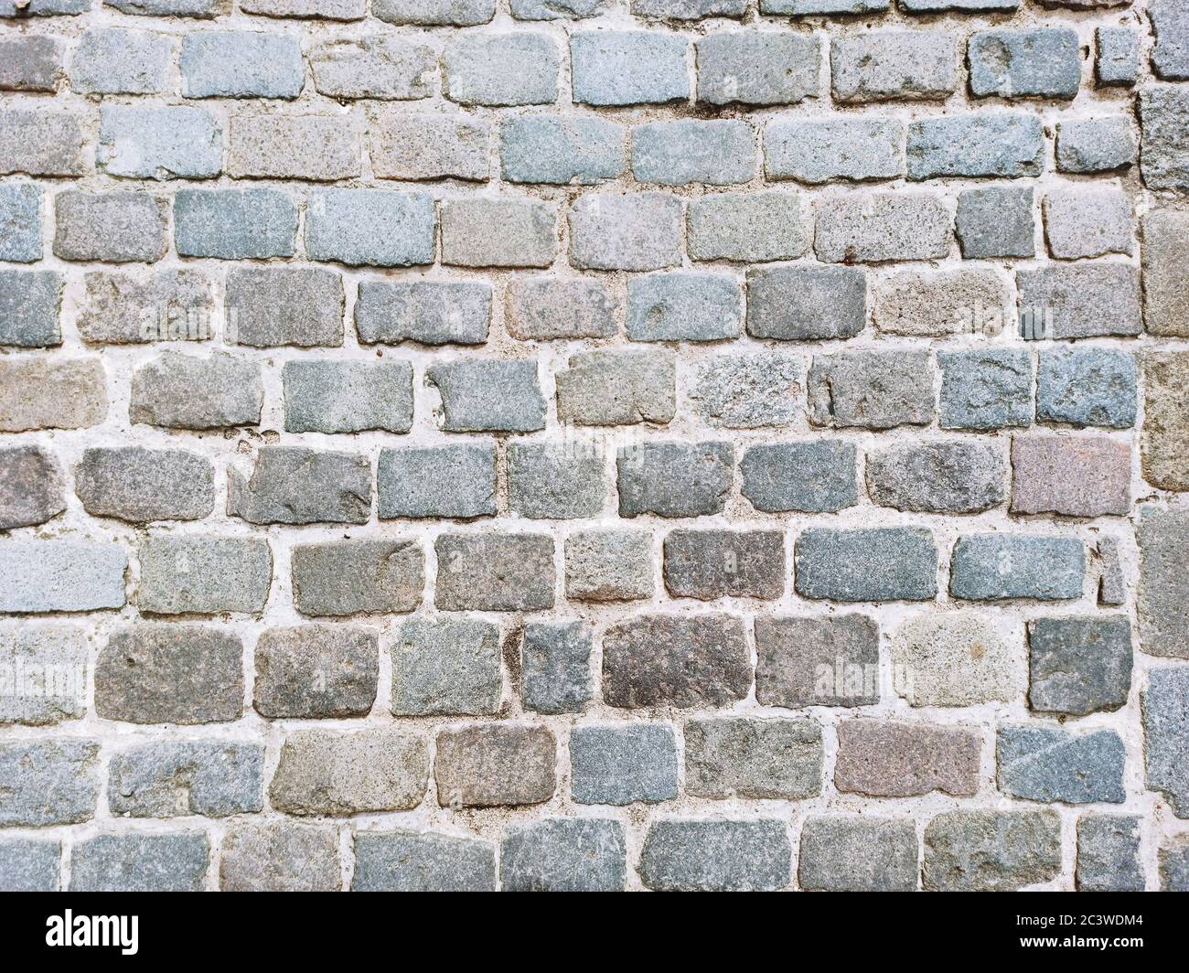 Abstract cobblestone floor. Abstract background with stone texture from above. Stock Photo
