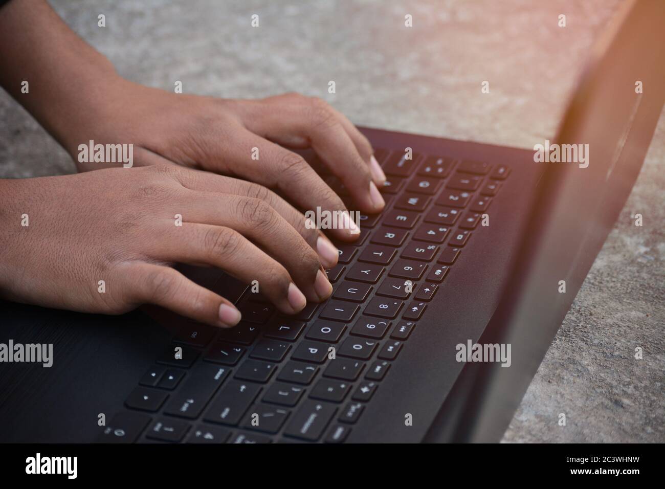 Businessman using laptop with hands typing on a keyboard Stock Photo