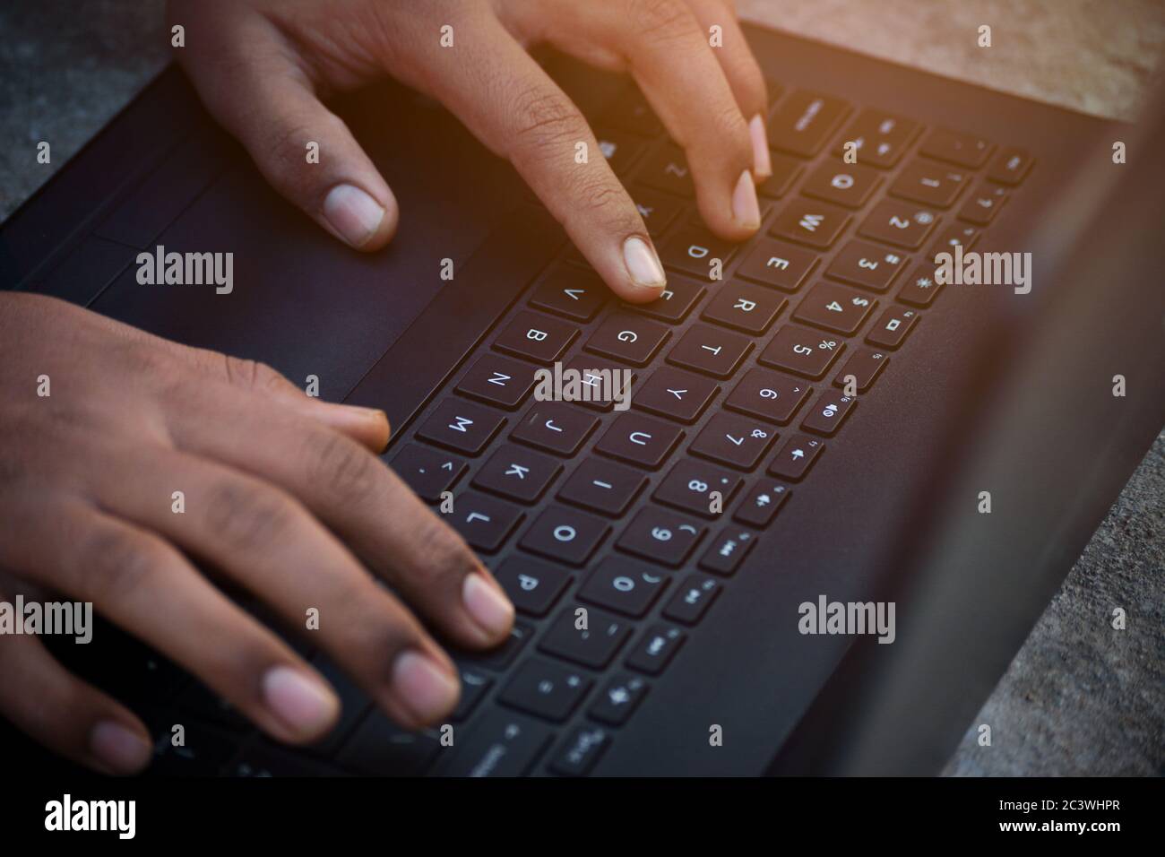 Businessman using laptop with hands typing on a keyboard Stock Photo