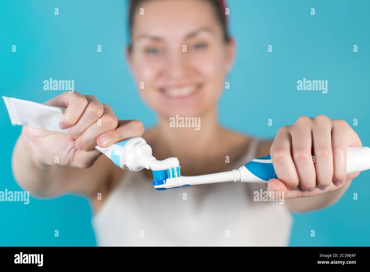 Close-up of a toothbrush and paste in the hands of a girl Stock Photo ...