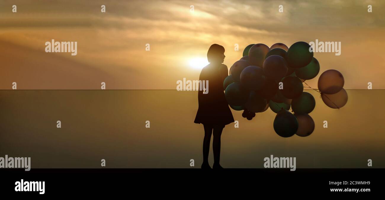 silhouette woman with ballooon on high building in twilight sunset on banner background Stock Photo