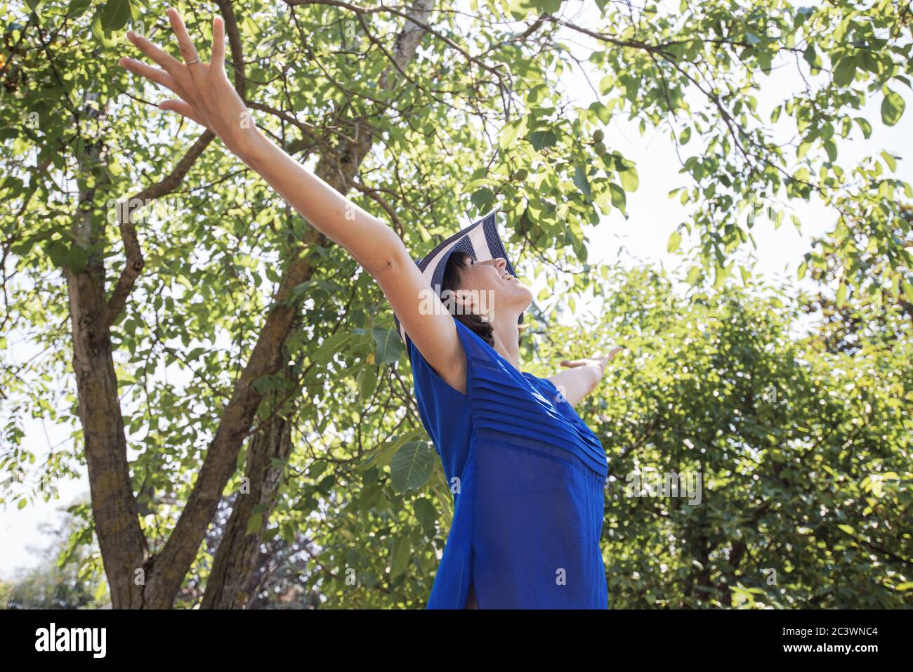 Standing woman in blue shirt hi-res stock photography and images - Alamy