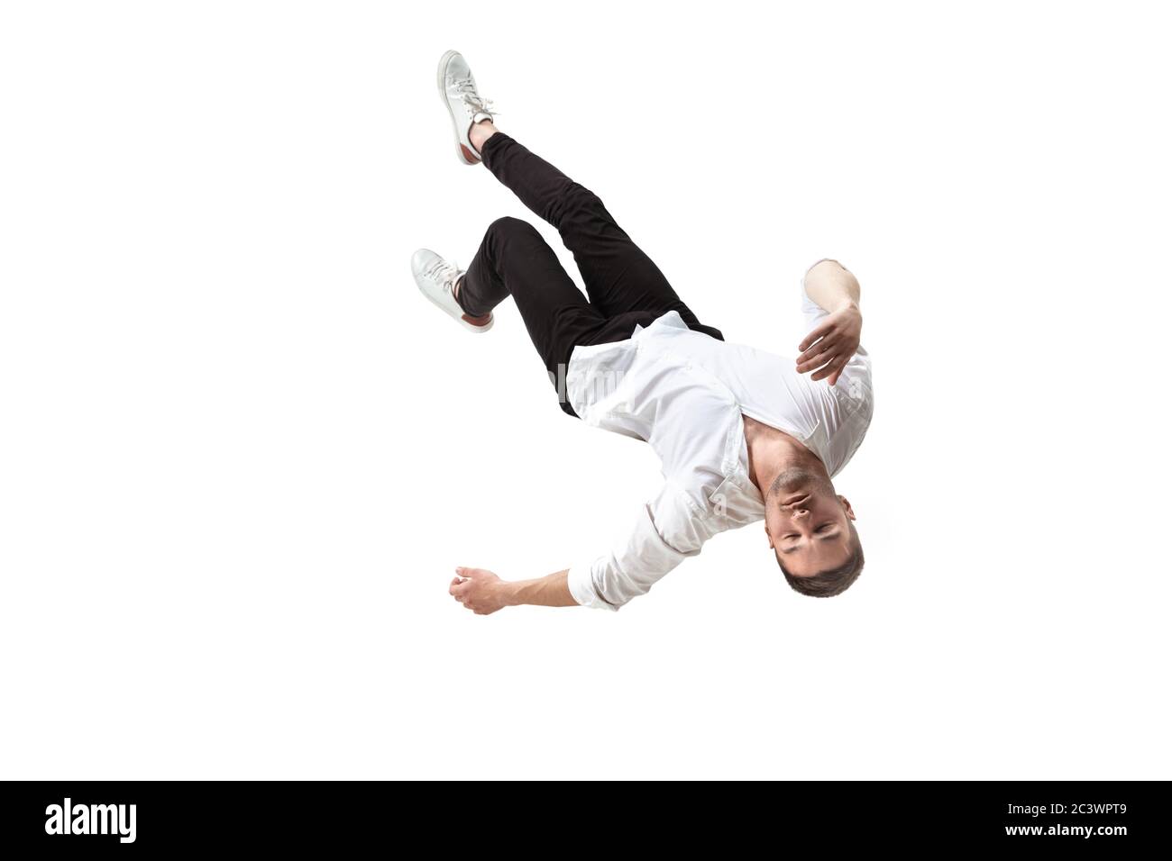 Mid-air beauty cought in moment. Full length shot of young man hovering in air and keeping eyes closed. Levitating in free falling, lack of gravity, flying. Freedom, emotions, artwork concept. Stock Photo