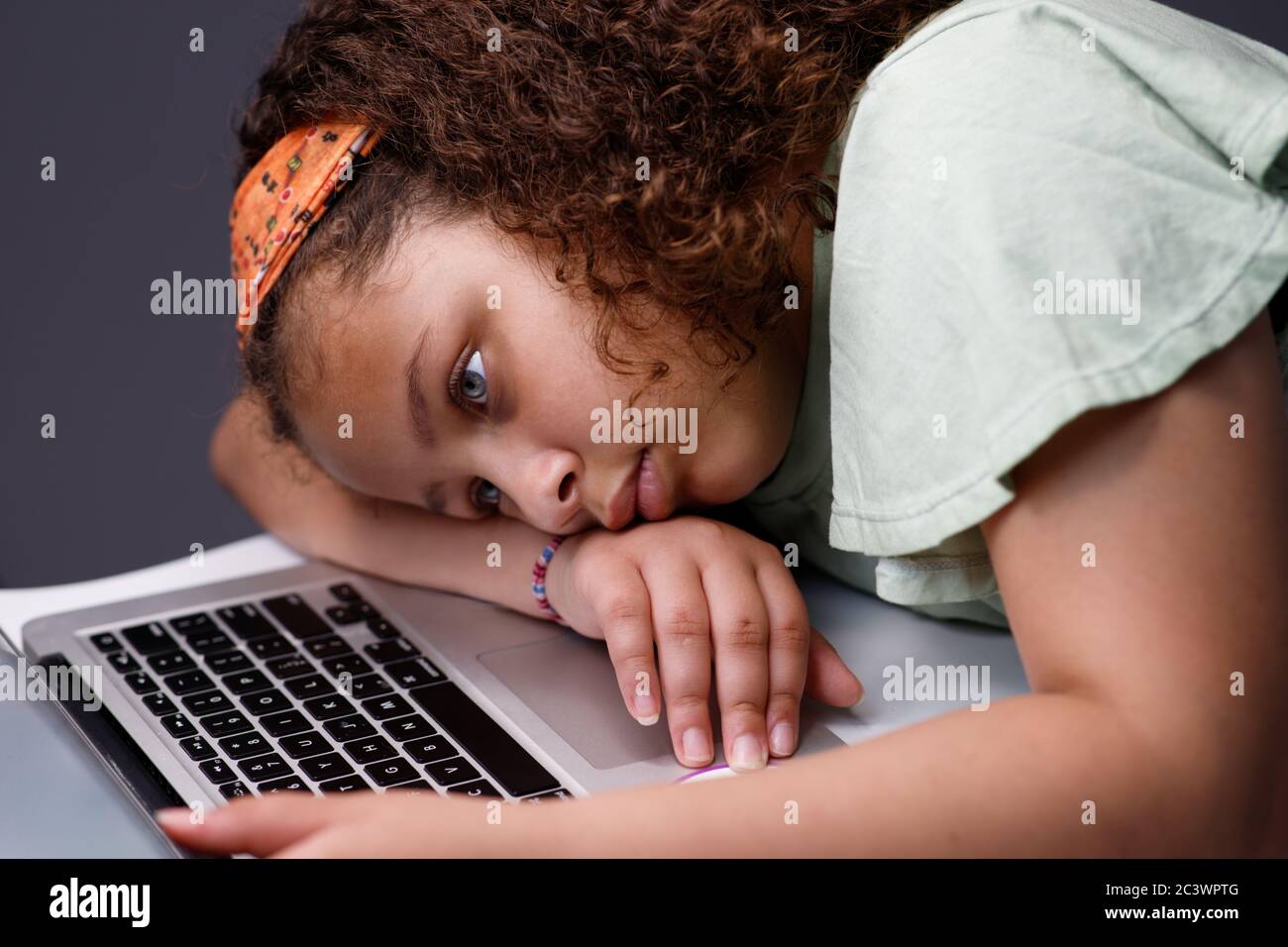 Tired girl working on a laptop Stock Photo