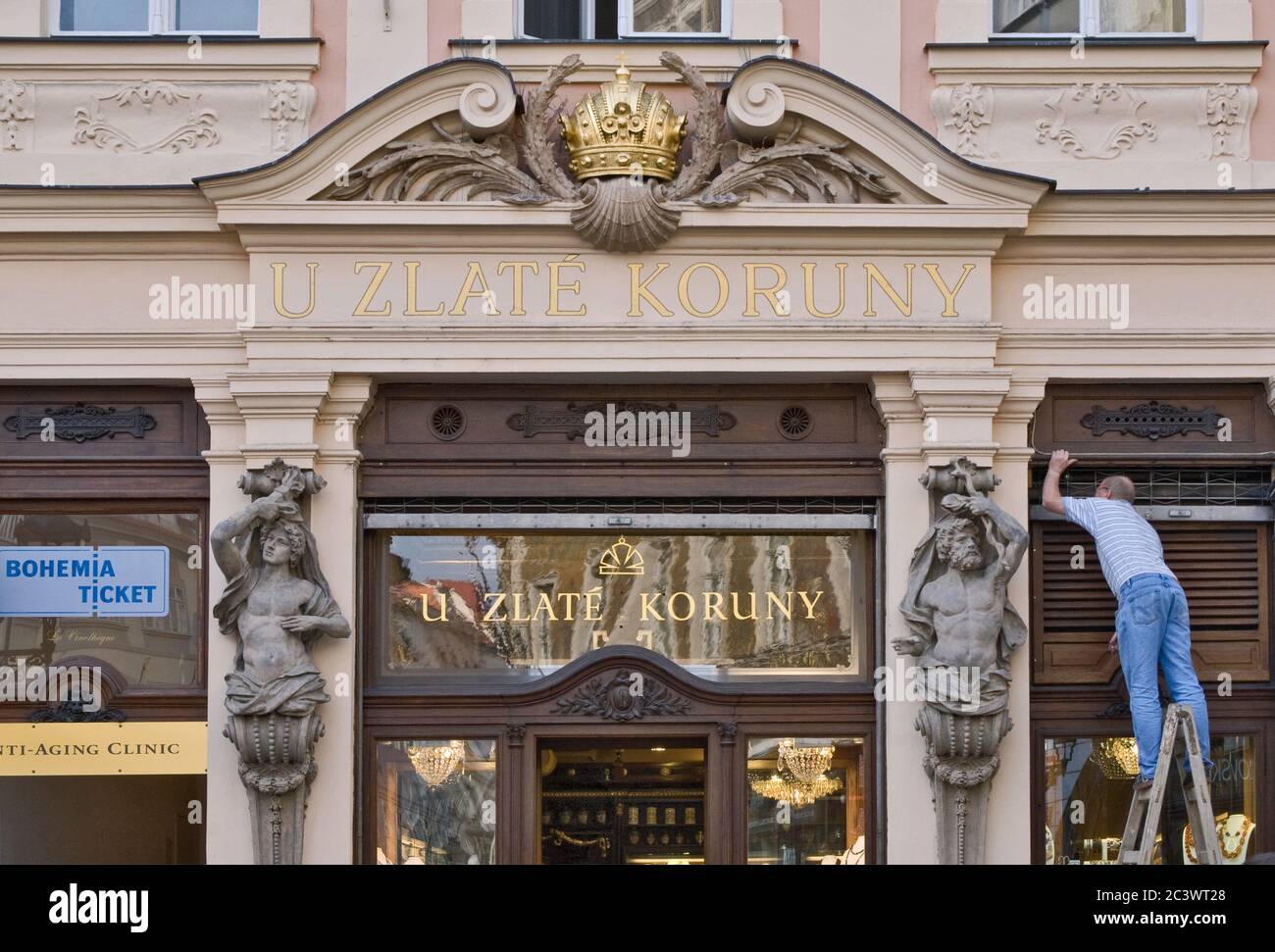 Atlants at entrance to 'At Golden Crown' store at Male Namesti in Old Town, Prague, Czech Republic Stock Photo