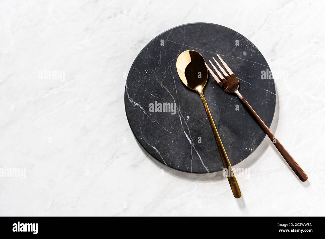 fork and spoon on a black marble tray Stock Photo