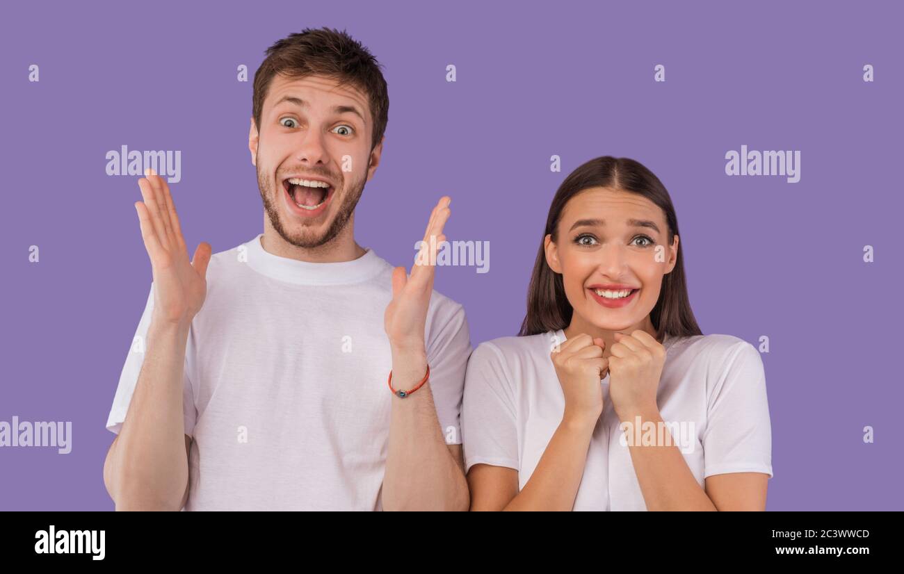 Excited young couple screaming happily at camera Stock Photo