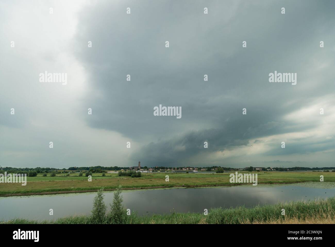 Thunderstorm over dutch river landscape Stock Photo