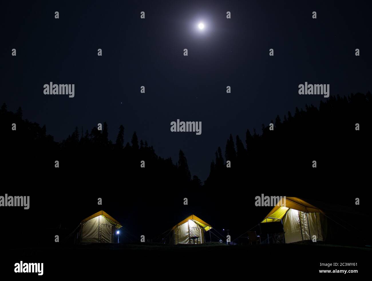 Night camps with moon in Chopta, Uttrakhand Stock Photo