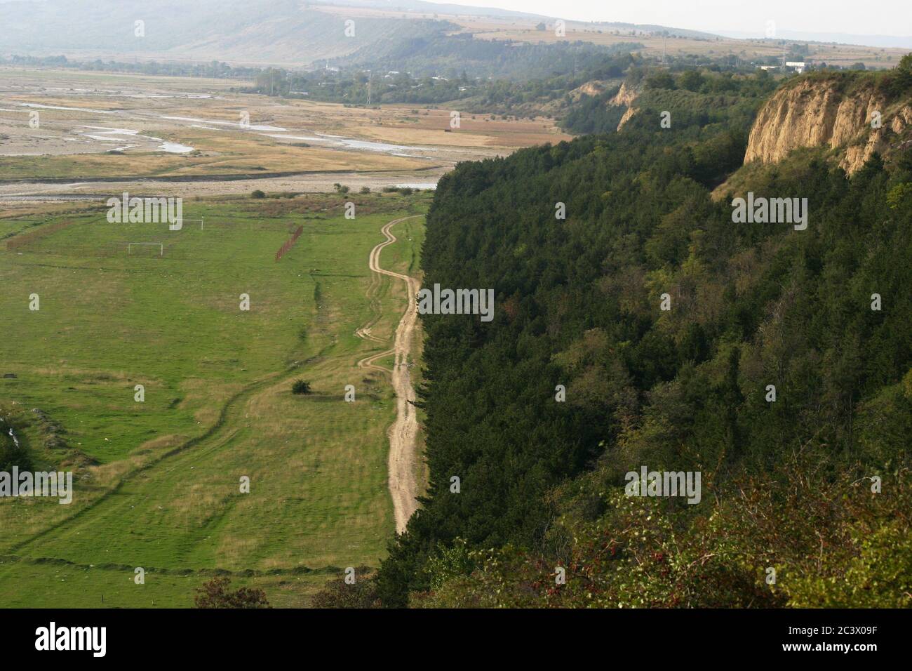 Cliffs along the Putna river in Vrancea County, Romania. Dirt road in the valley. Stock Photo