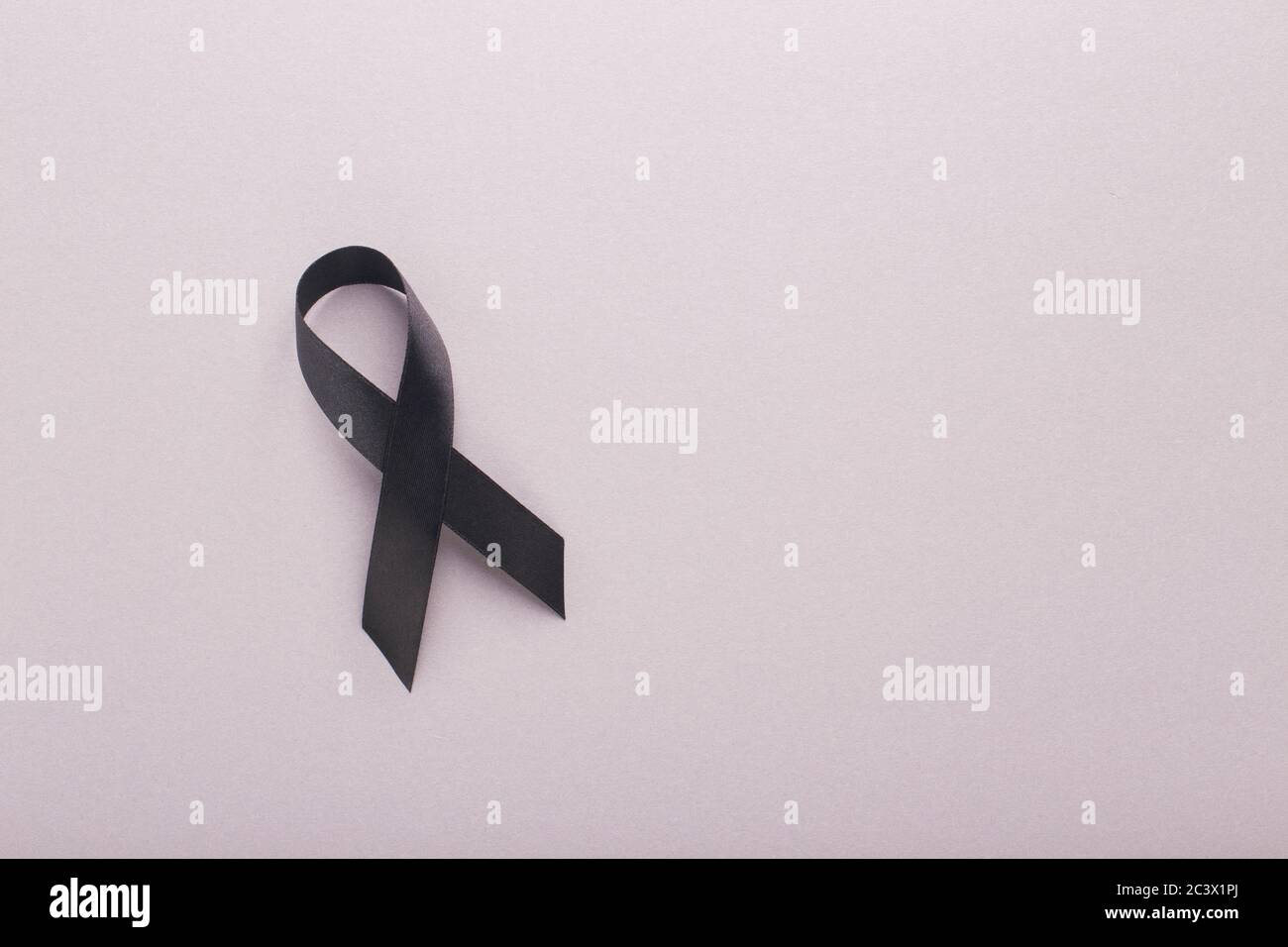 Realistic Black Awareness Ribbon Mourning Symbol of Support Stock Photo