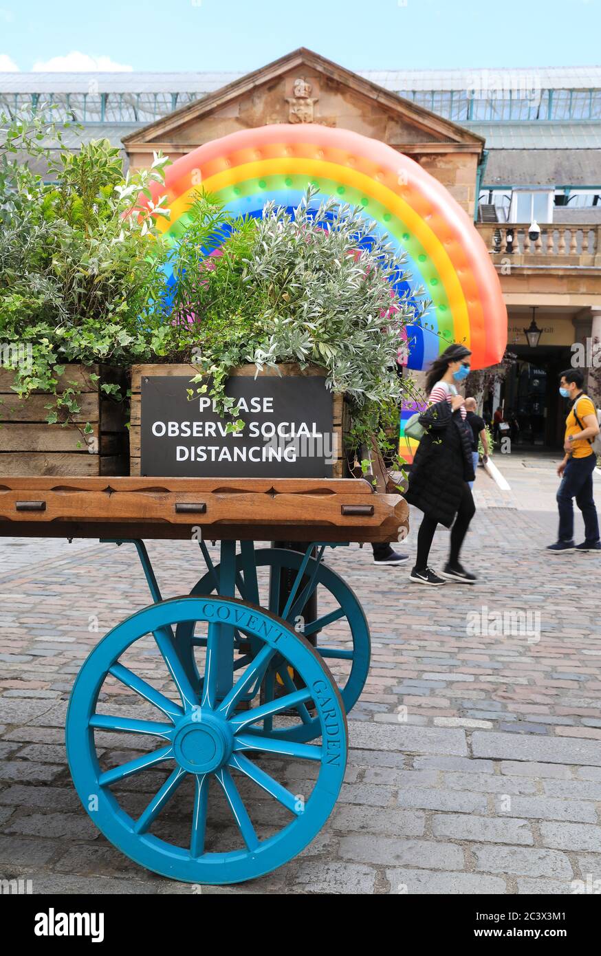 Inflatable rainbow installed at Covent Garden to encourage customers to return as coronavirus restrictions are eased and shops and restaurants reopen, in London, UK Stock Photo