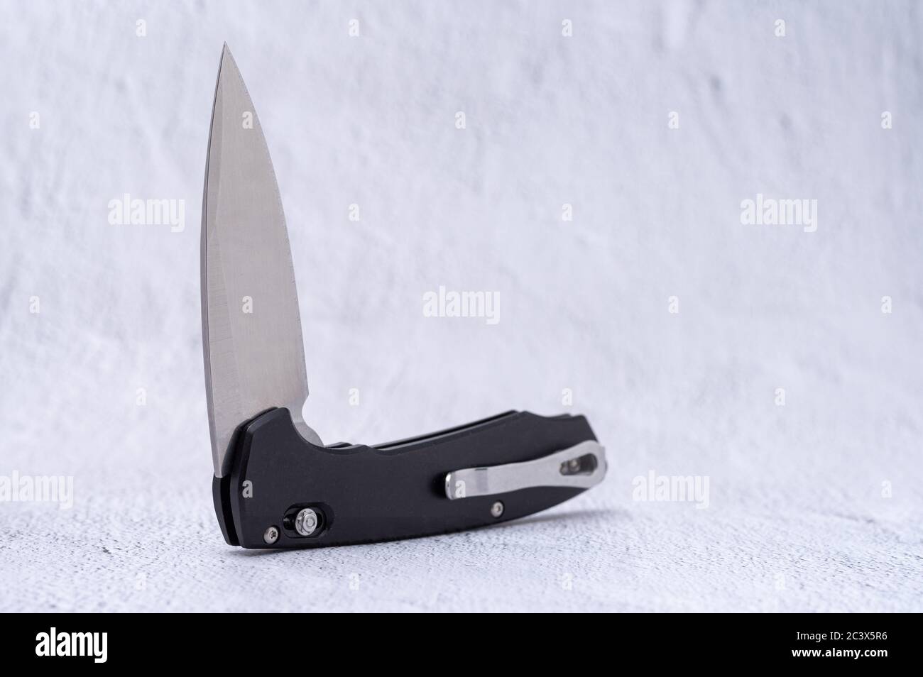 Folding knife with auto ejection system. Mirrorpolished knife blade