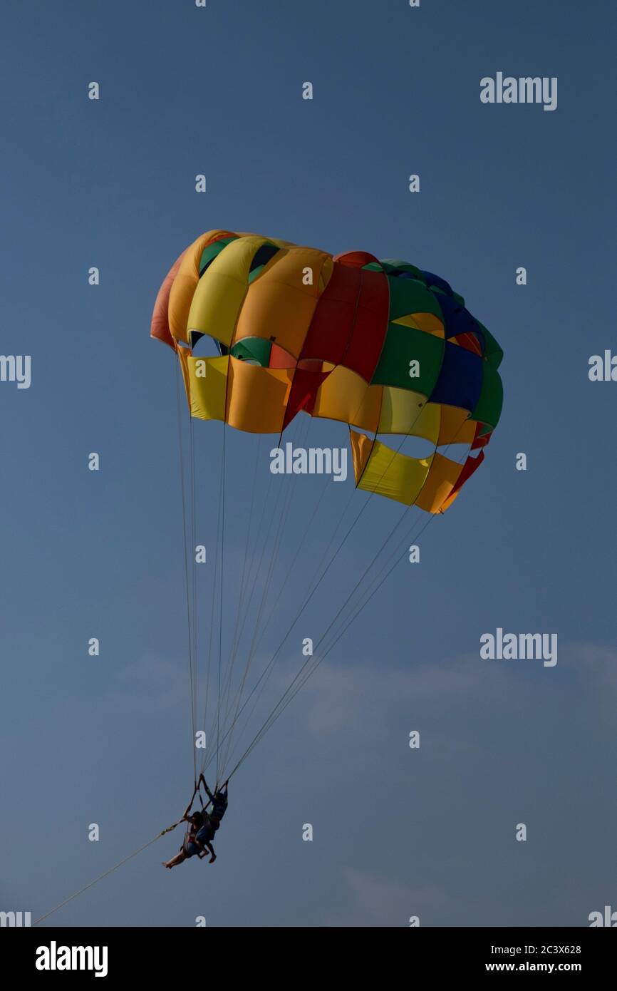 Tourists enjoying Parasailing in Goa, India. Stock Photo