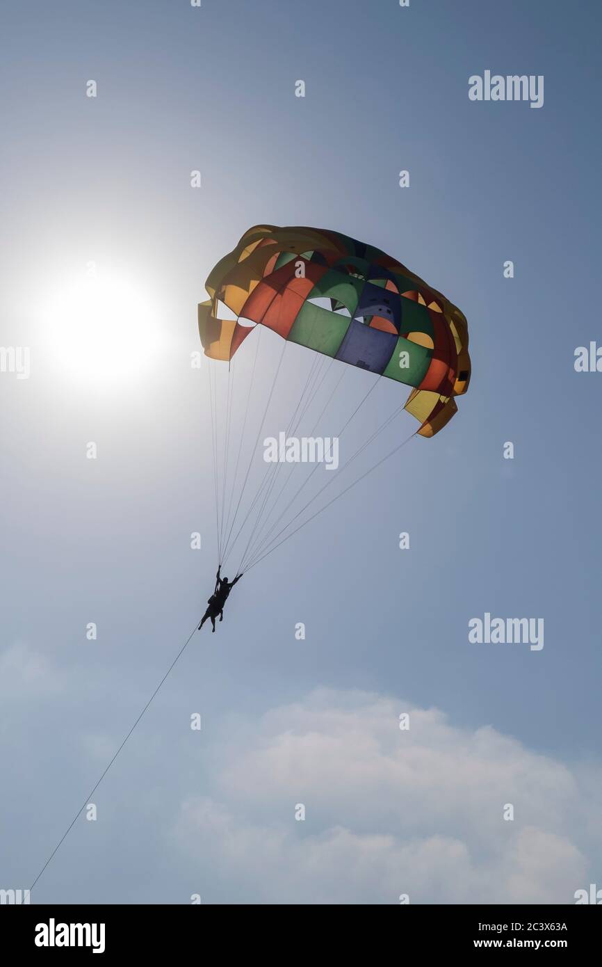 Tourists enjoying Parasailing in Goa, India. Stock Photo